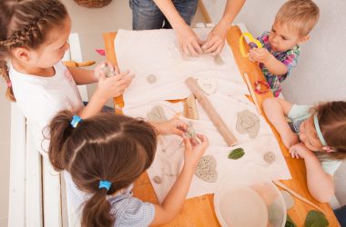 Happy children are engaged with modeling clay